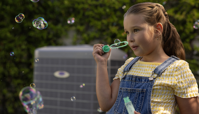 Carrier AC Unit outside, child playing outdoors